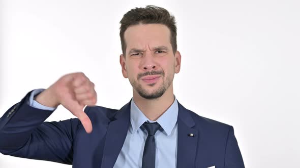 Portrait of Disappointed Young Businessman Showing Thumbs Down, White Background