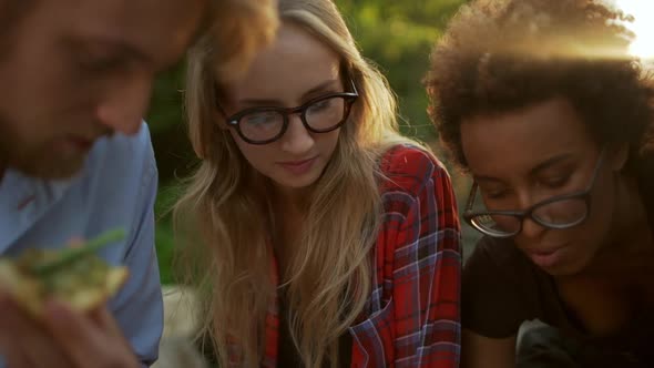 Close Up View of Caucasian Bearded Male Sitting with Blonde Female and African American Woman with