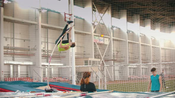 Young People on the Pole Vault Training on the Closed Stadium