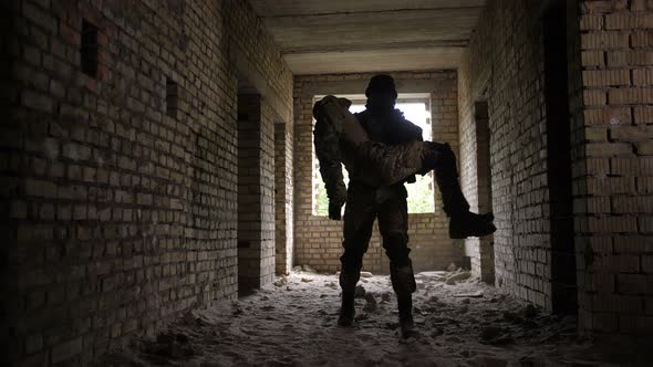 Soldier Carrying Wounded and Unconscious Comrade