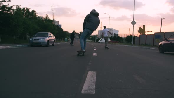 Group of Young People Skateboarding on the Road in the Early Morning Cinematic Shot Slow Motion