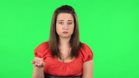 Portrait of Tired Girl Waving Hand and Showing Gesture Come Here. Green Screen