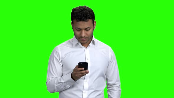 Young Man Using Mobile Phone on Green Screen