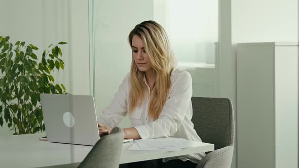 Young Businesswoman is Working on the Computer in Office