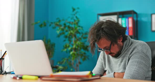 Tired Funny Weird Office Worker Sits on a Chair in the Corporate Office with Big