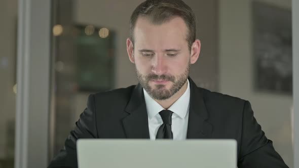 Close Up of Handsome Businessman Saying Yes with Head Sign at Night