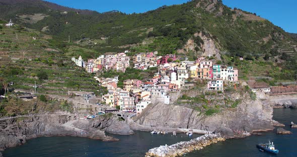 Beautiful small historic town Manarola on rocky cliff, Italian coast. Popular travel destination - d