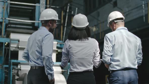 Factory Supervisors Inspecting Workshop