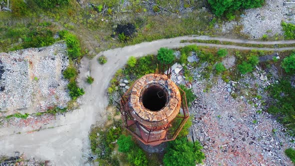 Old industrial chimney. Brick pipe of long built on the desolate factory position. Top aerial view.