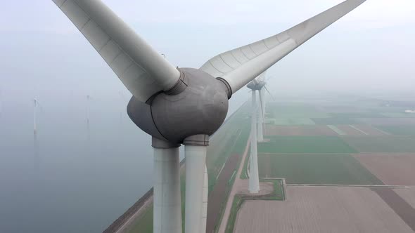 Aerial View of a Giant Wind Farm Used for Renewable Energy on a Foggy Day