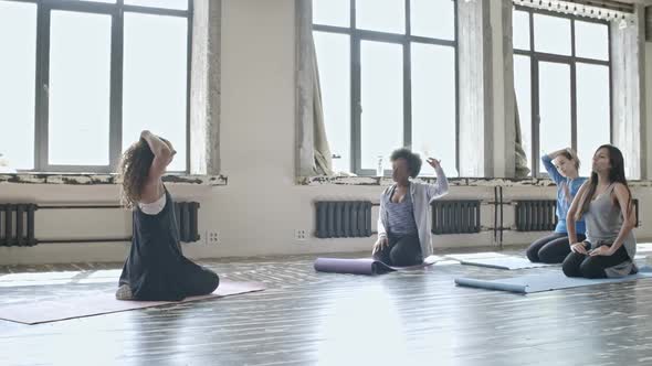 Women Warming Up in Yoga Class