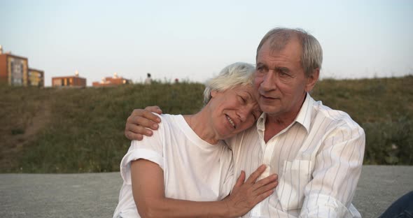 Elderly European Couple Hugging and Chatting