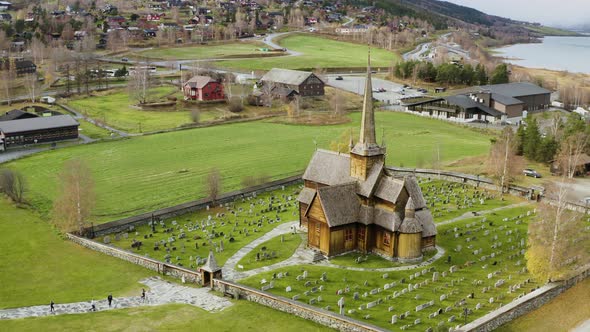 Scenic View On Lom Stavkyrkje - Lom Stave Church In Norway During Autumn - aerial drone shot