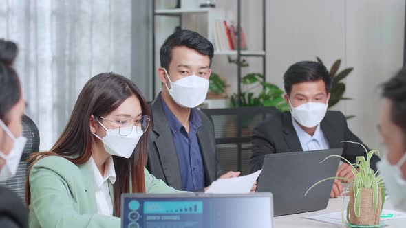 Asian Team Wearing Face Mask Have Meeting In A Conference Room. They Share Opinions