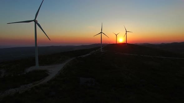 Aerial view of windmills at beautiful colorful sunset