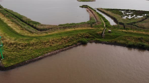 Aerial Looking Down At Grass Verge Path Beside River Noord In Ridderkerk. Pedestal Down