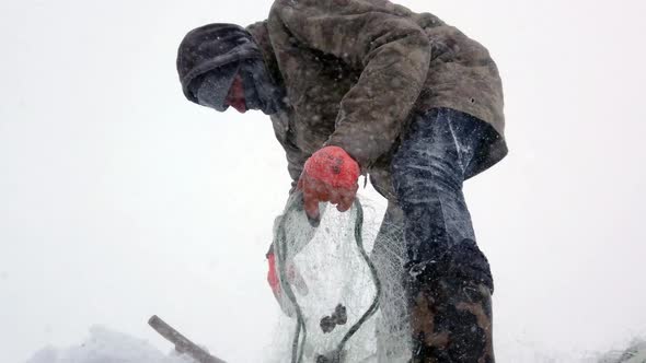 Fishing on Frozen Lake in Snowy Weather