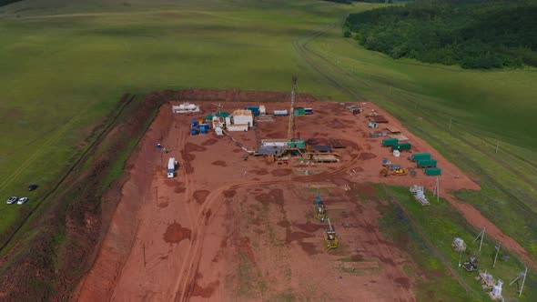 Oil and Gas a Land Rig Onshore Drilling Rig in the Middle of a Rice Field Aerial View From a Drone