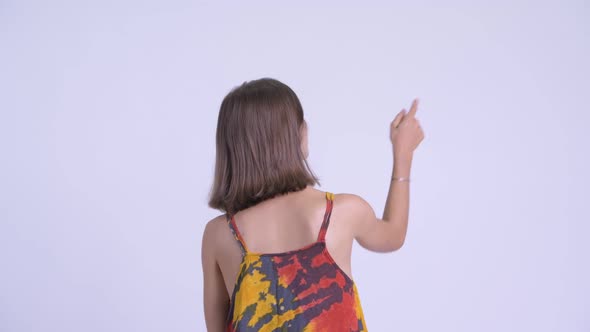 Rear View of Young Hipster Woman Pointing Finger