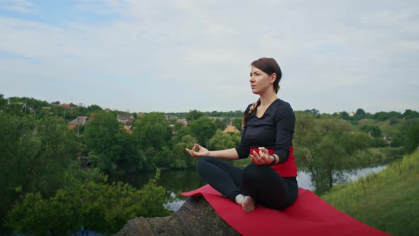 Happy Young Woman Doing Yoga Outdoors