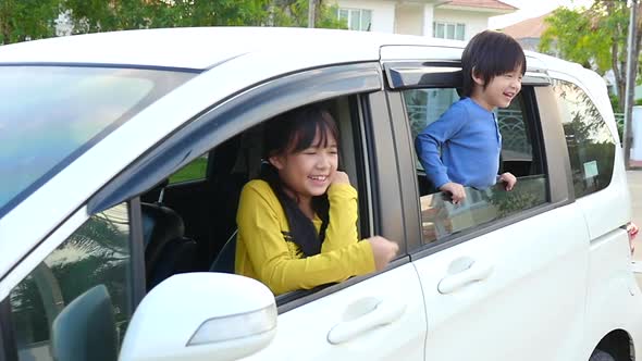 Happy Asian Children Sitting In The Car