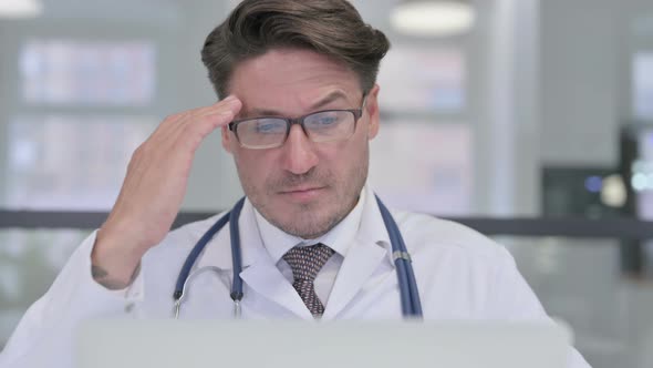 Close Up of Doctor with Laptop having Headache