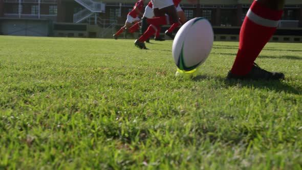 Rugby player kicking the ball from the kicking tee in the stadium 4k