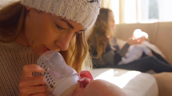 Lesbian couple feeding milk to their babies 4k