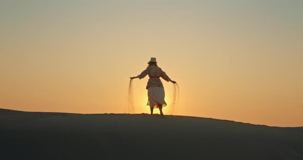 Woman Turning Around in Desert at Golden Hour
