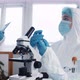 Professional Virologist Doctor Scientist in Protection Suit and Shield Creating New Coronavirus - VideoHive Item for Sale