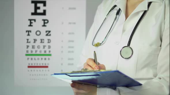 Hard-Working Optician Prescribing Medication to Patient at Clinic, Healthcare