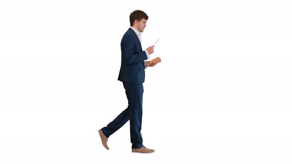 Businessman Walking and Writing Down His Ideas on White Background