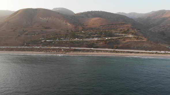 Aerial zoom into the famous Malibu RV Resort in Malibu, California.  Drone flight over the ocean to