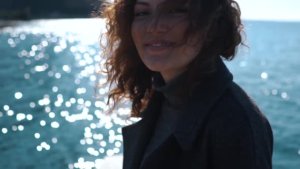 Slow motion shot of smiling redheaded woman at harbour