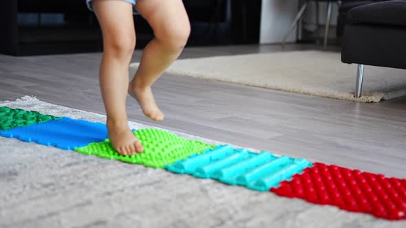 Close Up View of Little Girl Walks on a Massage Mat