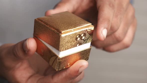 Young Man Hold a Wedding Ring in a Box