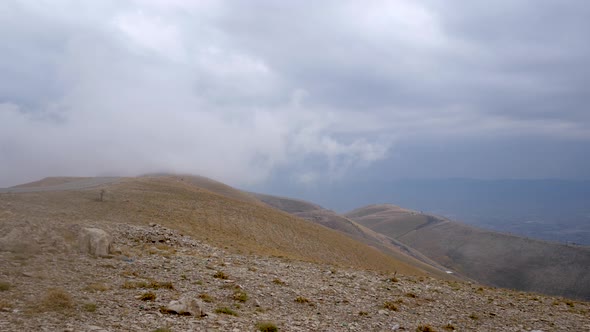Clouds blowing over a high mountain pass in the hills in Kurdistan Iran to the left and Iraq to the