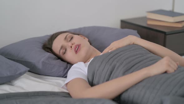 Woman Coughing While Sleeping in Bed