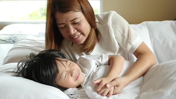 Cute Asian Child Sleeping On White Bed With Mother Care Slow Motion