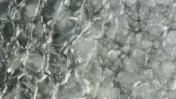 Ice sheets ripple with waves on lake