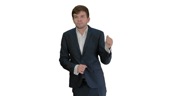 Arrogant businessman in a suit dancing on white background