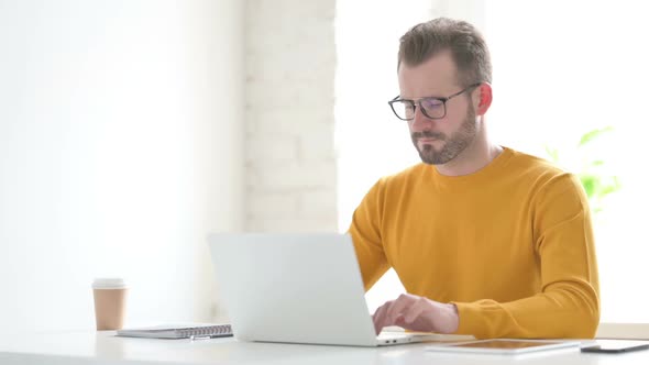 Man Working on Laptop in Office