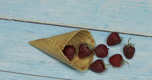 Berry Ice Cream Berries of Strawberry in a Waffle on a Blue Wooden Background