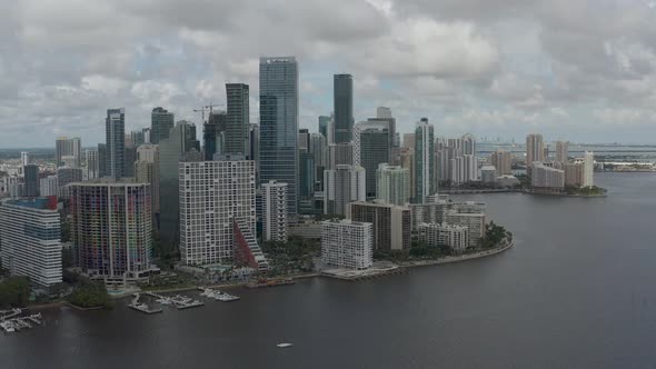 Aerial with semi-orbital path along multiple buildings in downtown Miami