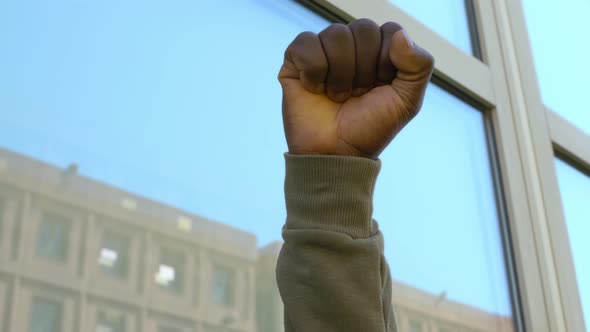 political gesture - clenched fist of black man raised against racism