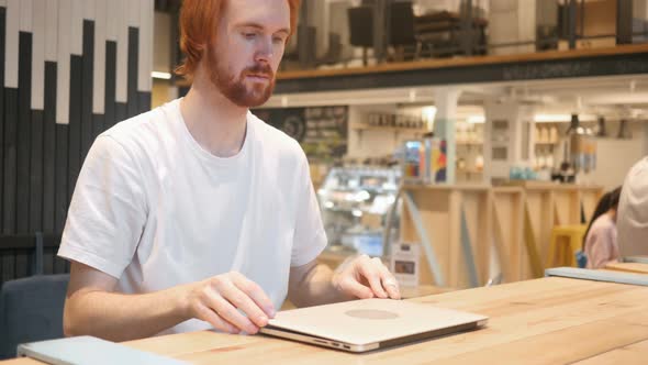 Redhead Beard Man Leaving Cafe after Working on Laptop