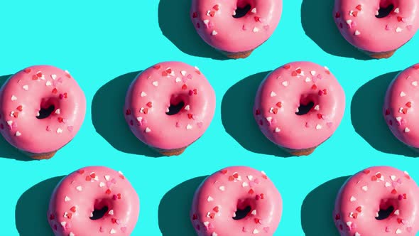 Pink Glazed Donut Motion Pattern on Blue Background. Creative Concept alt