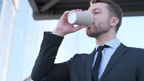 Businessman Drinking Delicious Coffee on the City Street