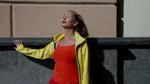 City Dweller Woman is Enjoying Sunshine Outdoors Closing Eyes and Feeling Warm of Sun