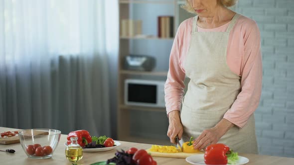 Elderly Lady Cutting Fresh Salad, Loving Husband Hugging Wife, Family Care